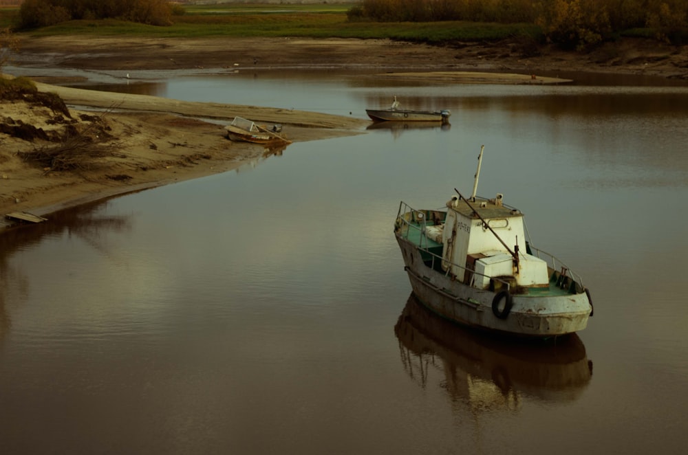 white and black boat on river during daytime