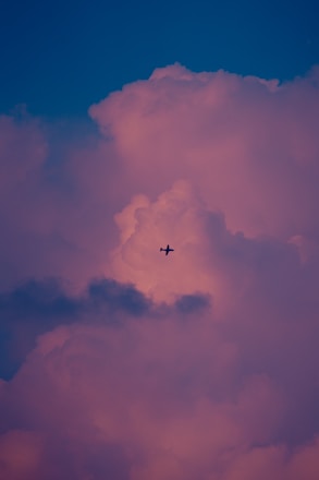 A sleek airplane soaring above clouds during sunset, symbolizing seamless travel.