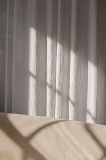 Soft natural light falling on a collection of finished atelier lumina garments.