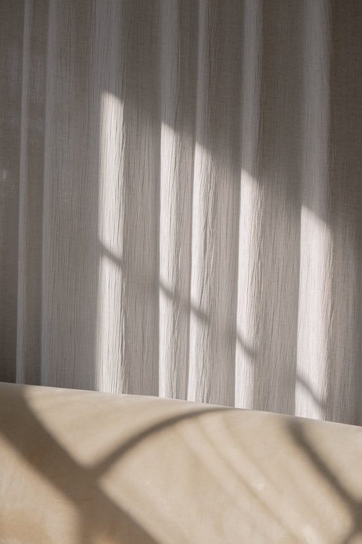 white and brown window curtain