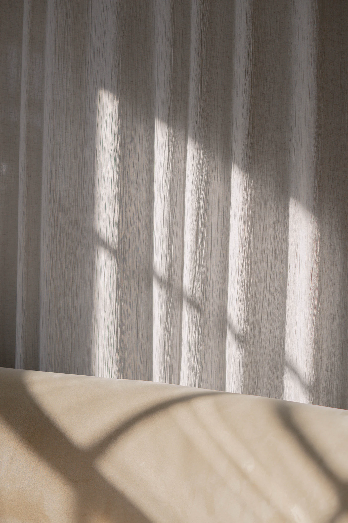 A warm, finished interior wall beside a curtained window