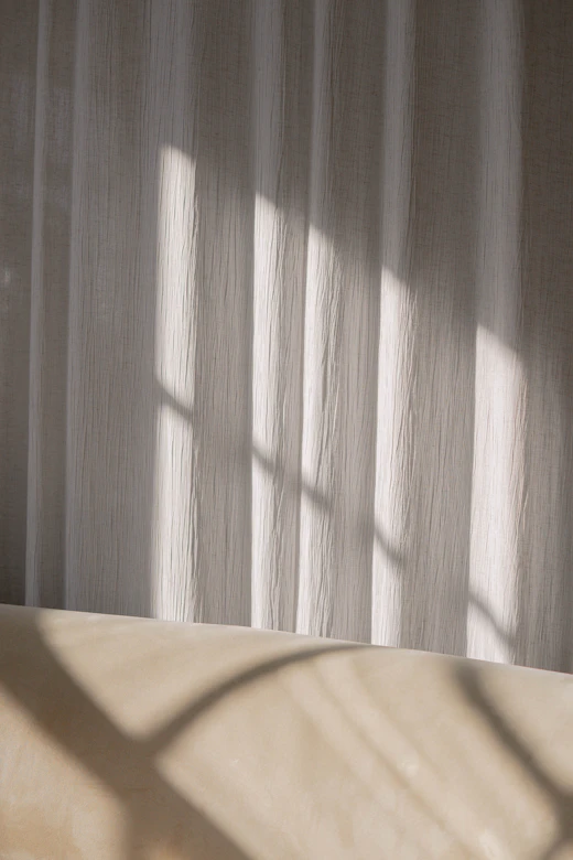 Morning light through a sheer white curtain