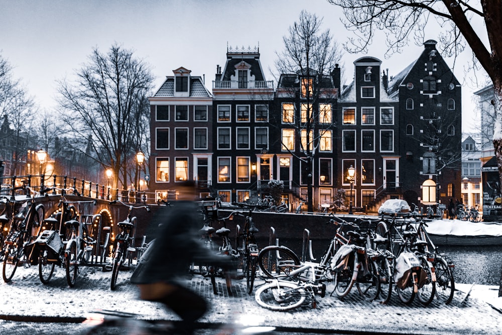 bicycles parked on road near building during night time