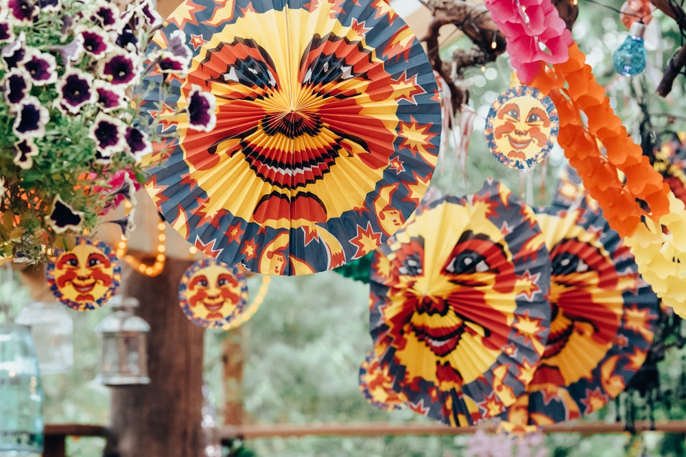 yellow and red umbrella hanging on brown wooden post