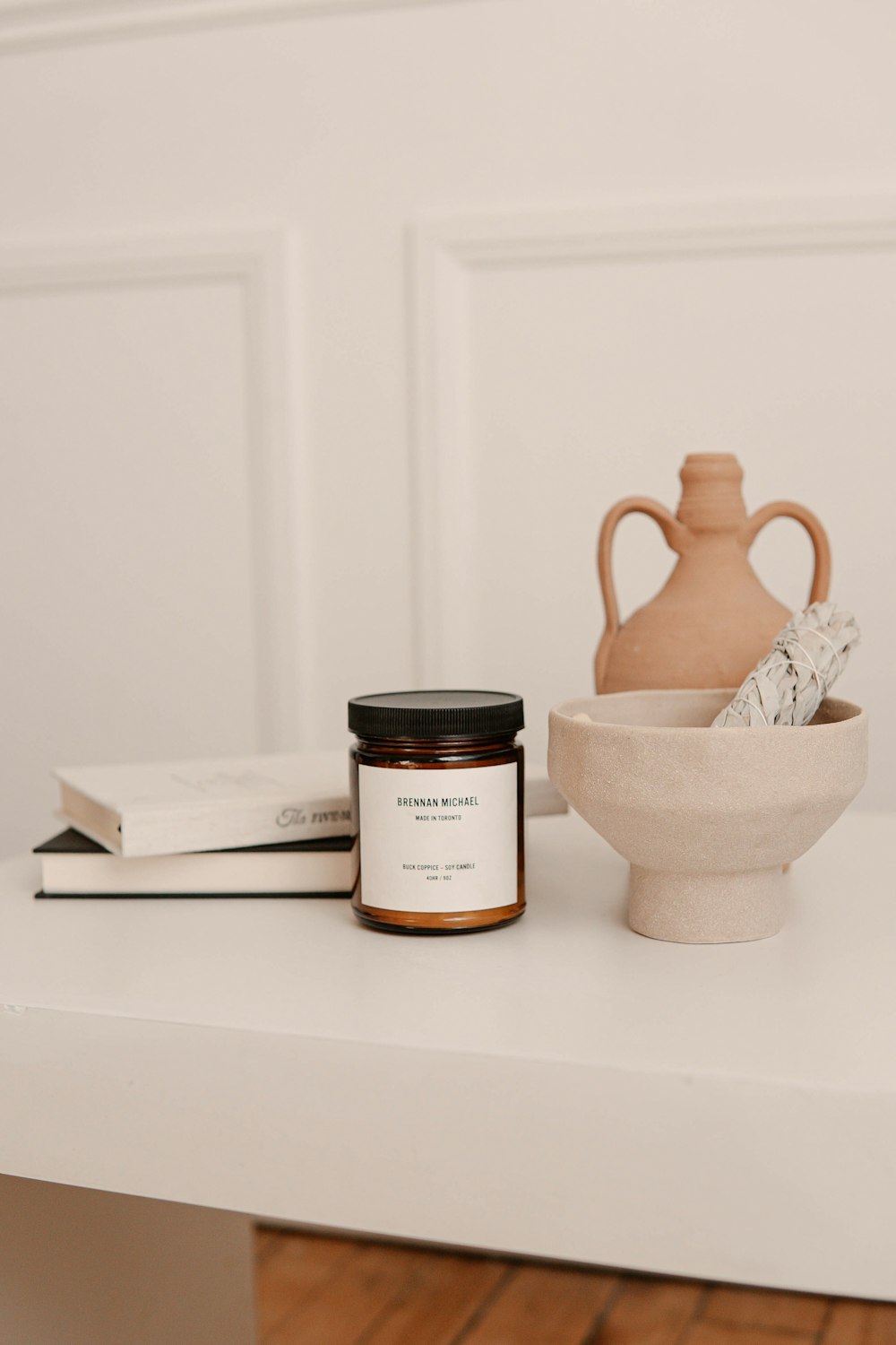 white ceramic jar on white table