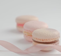white and pink macaroons on white surface