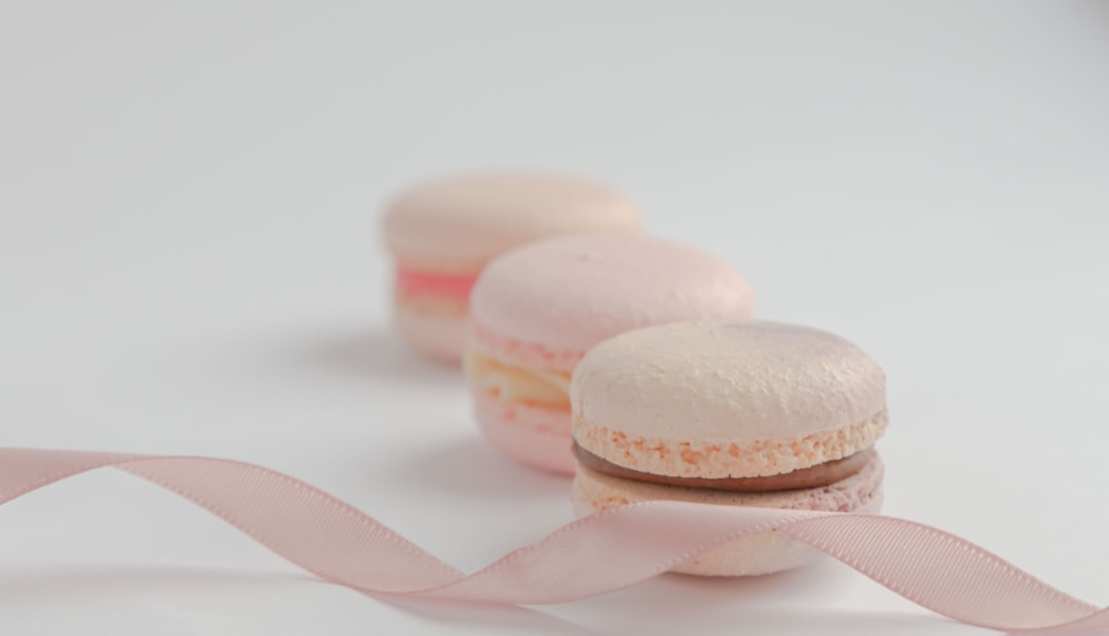 white and pink macaroons on white surface