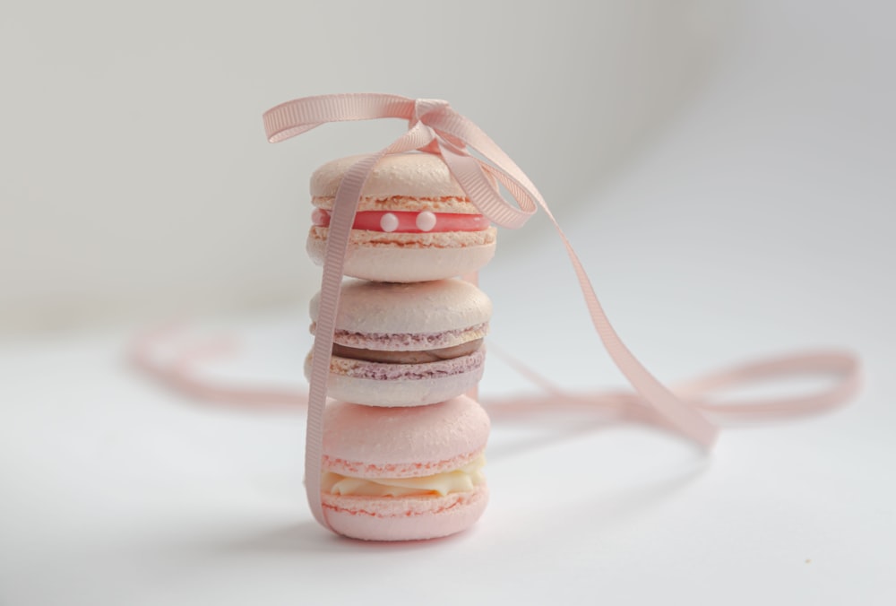 white and pink cupcake on white table