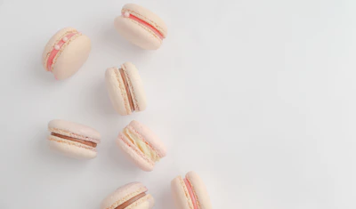 Close-up of matching pastel macaron accessory sets including bags and hats on white background.