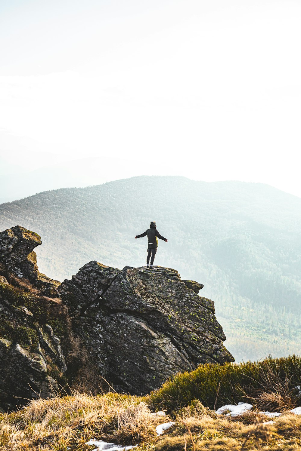 person standing on rock formation during daytime