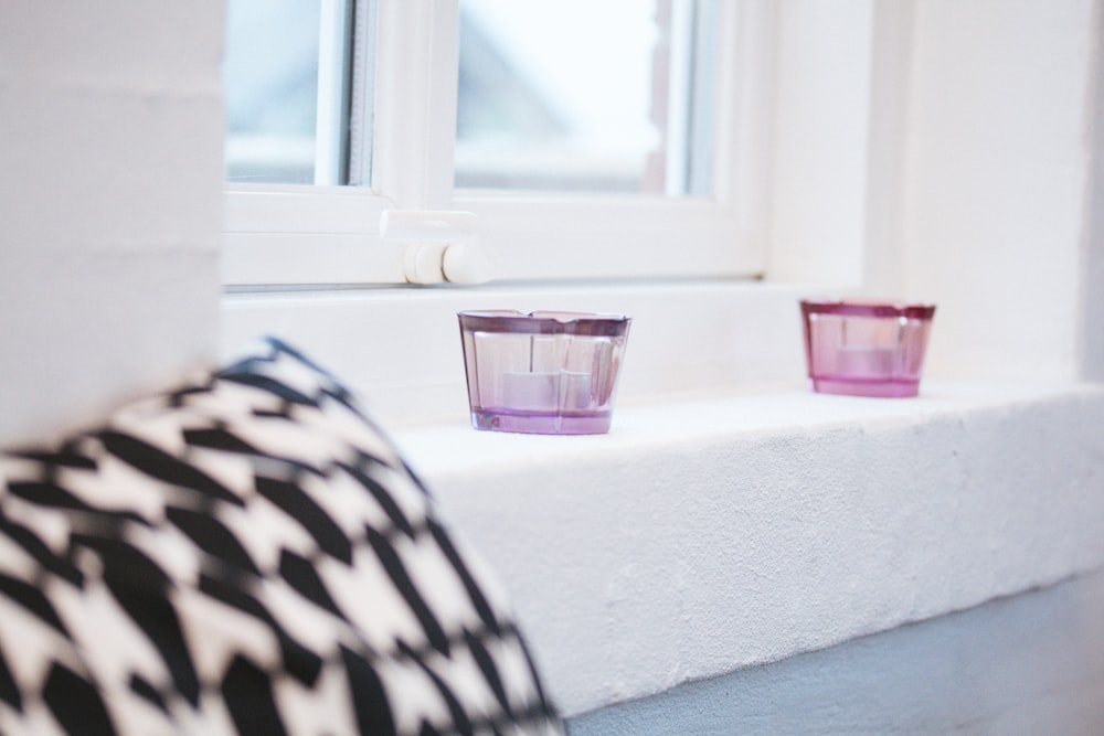 pink plastic cup on window