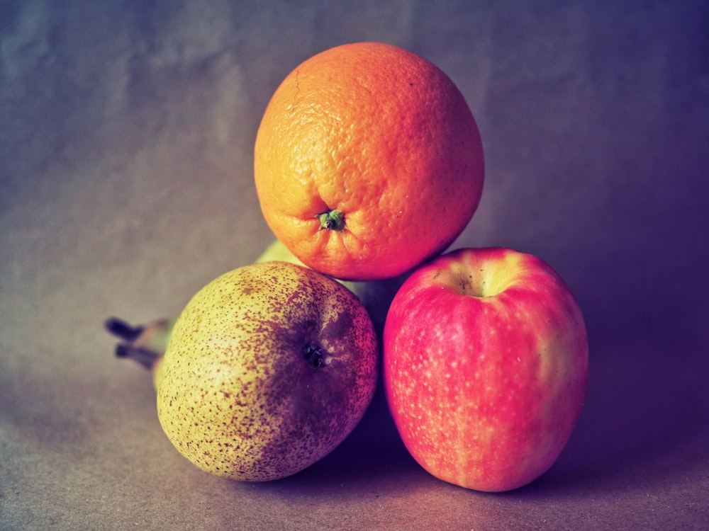 two orange fruits on gray surface