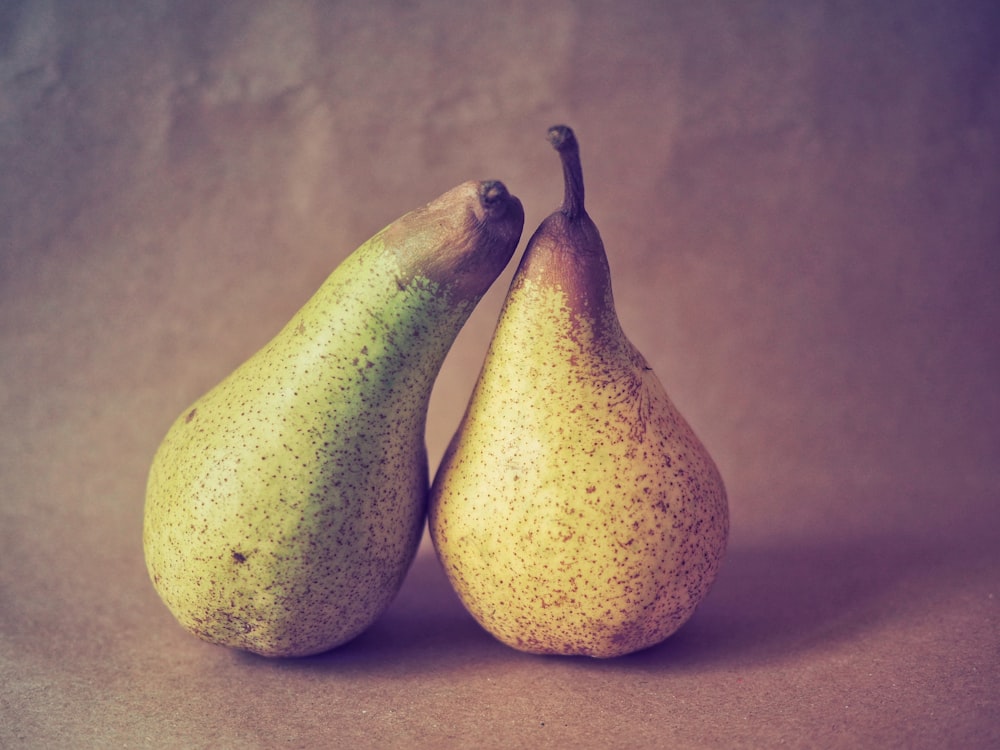 3 yellow oval fruits on brown wooden table