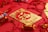 gold and white religious print book on red textile