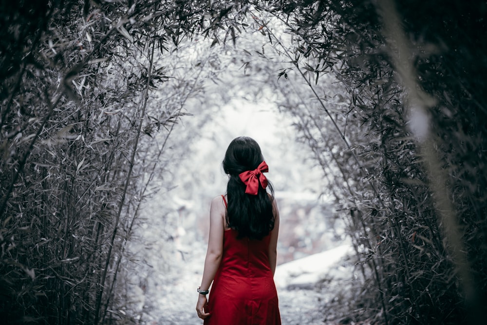 woman in red dress standing on snow covered ground