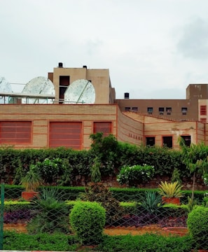 brown concrete building near green trees during daytime