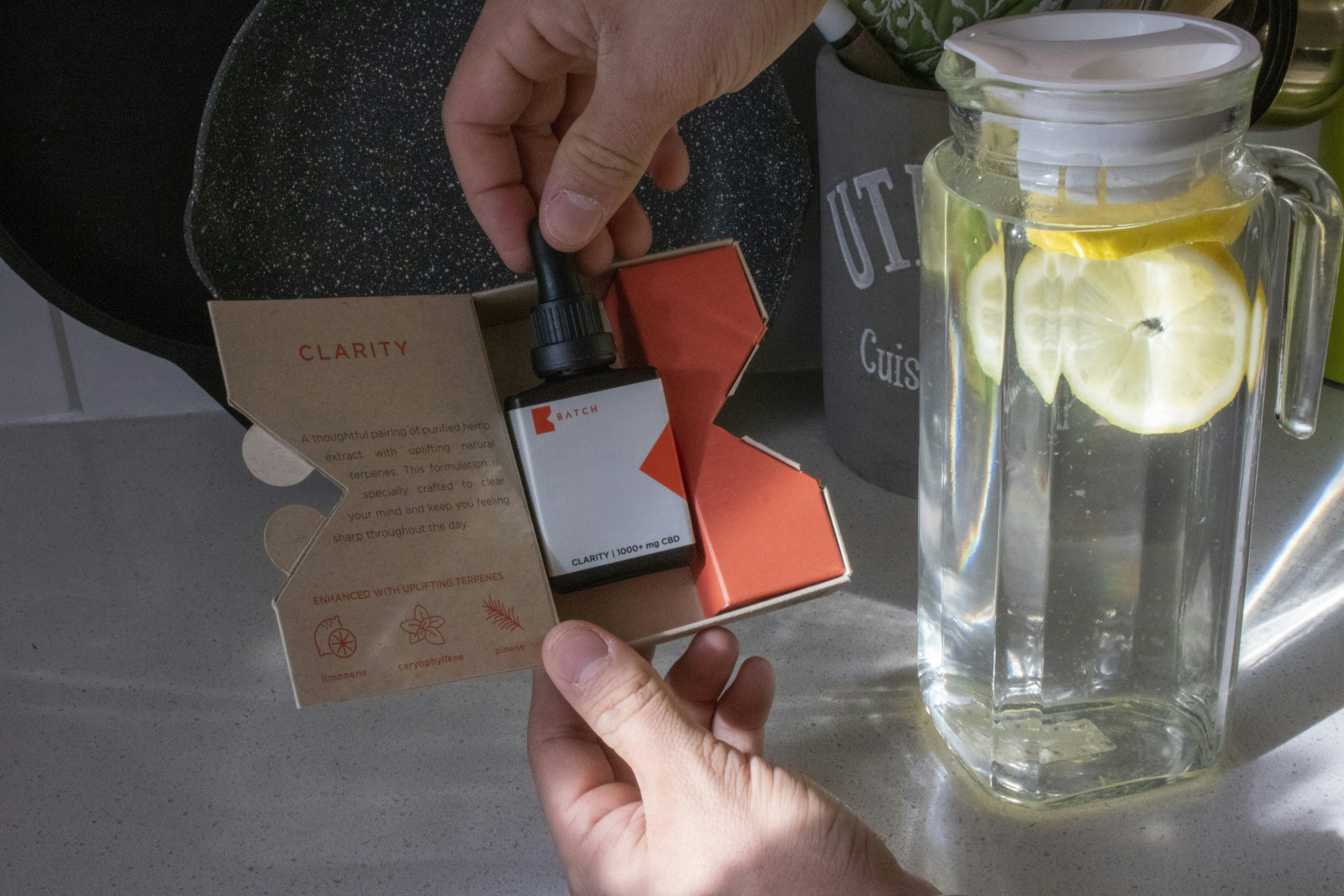 person holding black and white labeled bottle