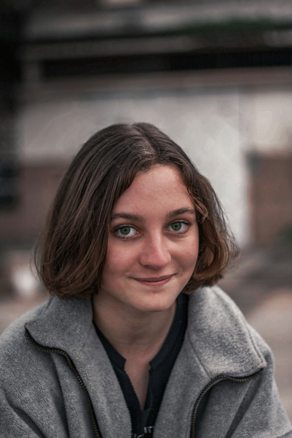 woman in gray sweater smiling