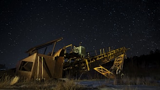 brown and black metal crane under starry night