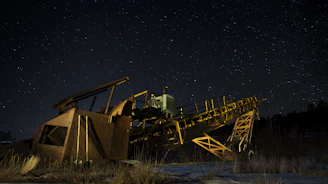 brown and black metal crane under starry night