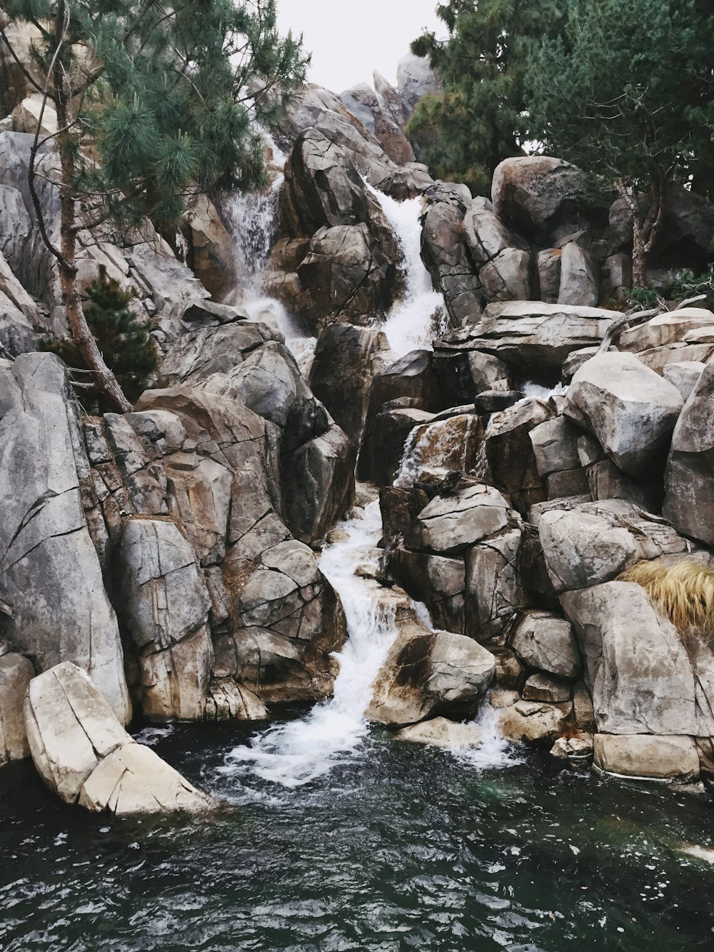 brown rocky river with water falls