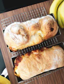 Freshly baked Mexican sweet bread cooling on a rustic wooden tray.