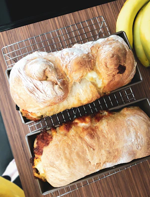Freshly baked Mexican sweet bread cooling on a rustic wooden tray.