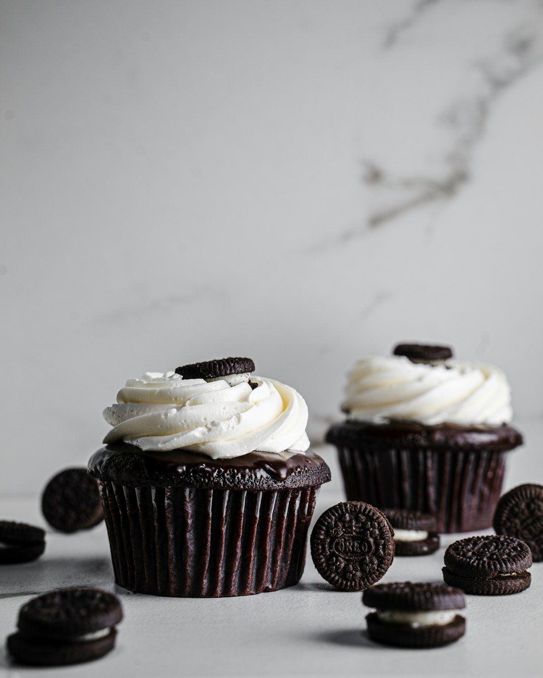 white and brown cupcakes on white table