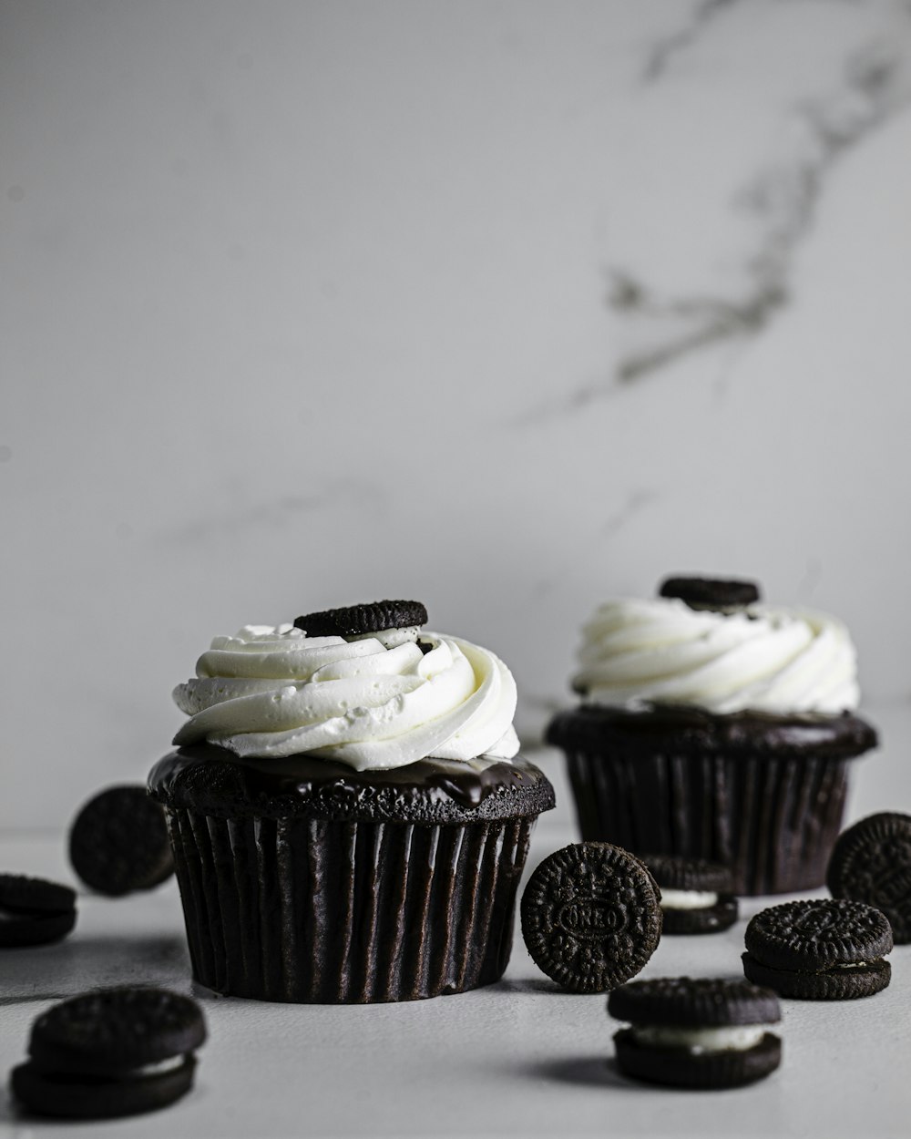 white and brown cupcakes on white table