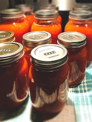 three clear glass jars on blue and white textile