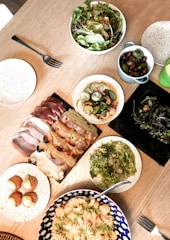 An inviting spread of assorted tapas dishes on rustic wooden table.
