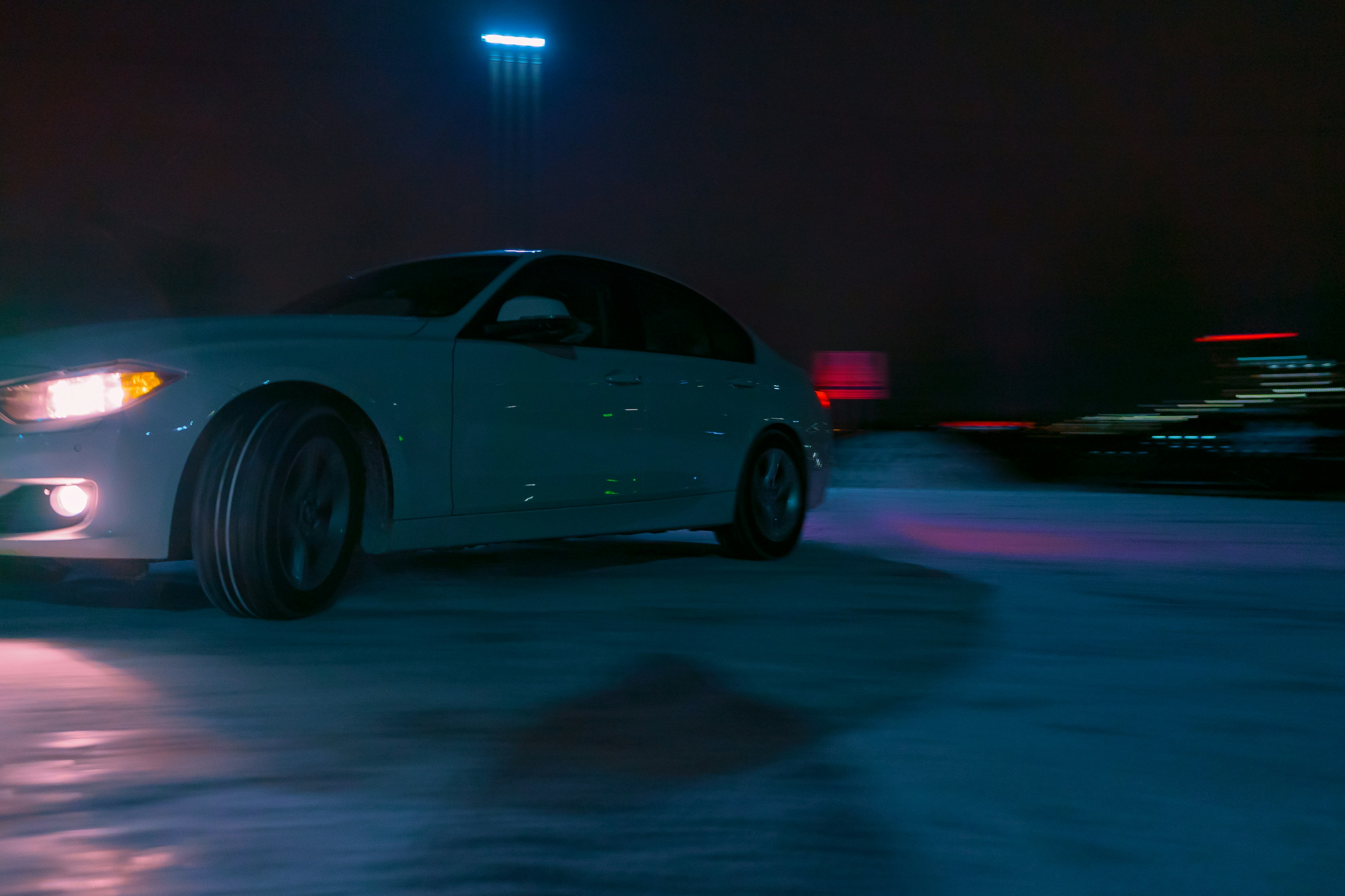 gray sedan on road during night time