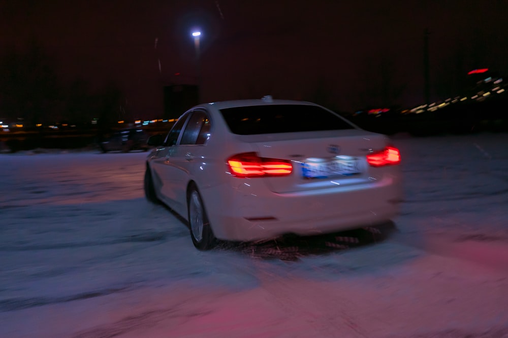 white car on road during night time