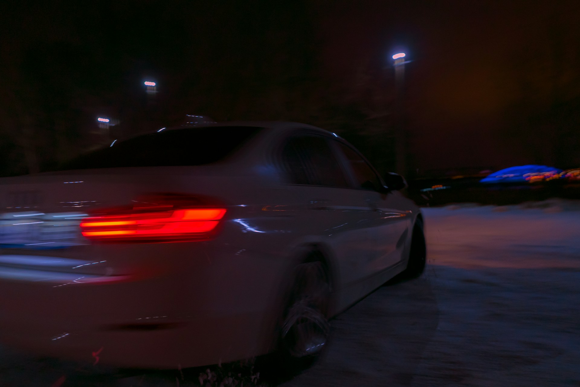 white car on road during night time