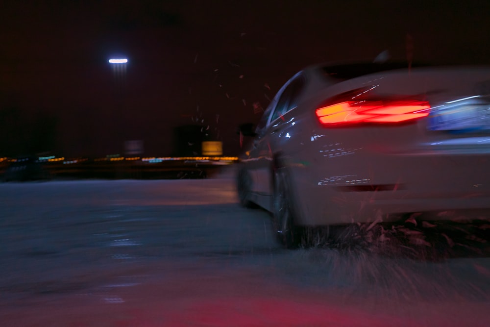 white car on road during night time