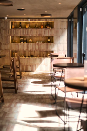 A warm, inviting cafe corner with Jharkhand-inspired decor and soft lighting highlighting a steaming cup of coffee.
