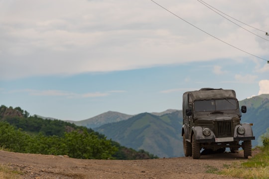 black suv on dirt road near green mountains during daytime in Kalavan Armenia