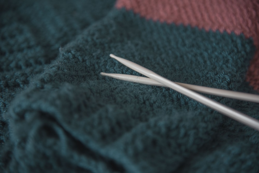 white coated wire on green and red textile