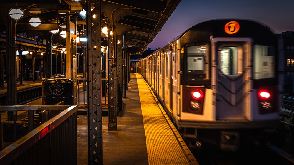 train station with lights turned on during night time