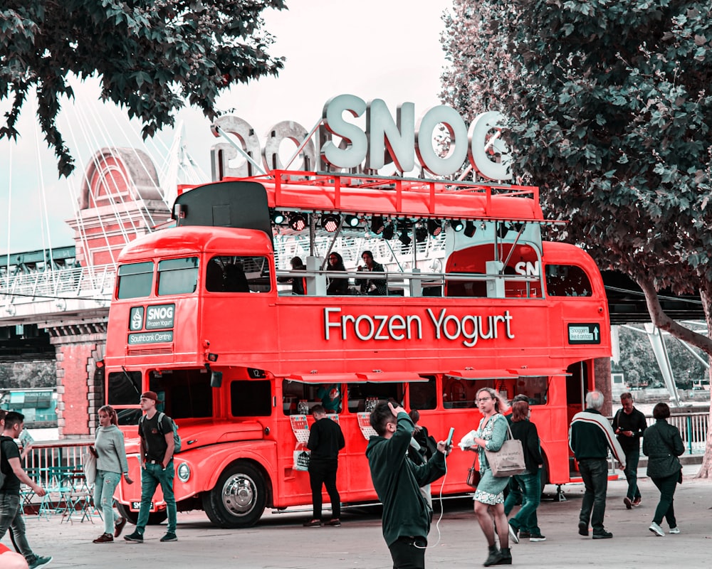 people walking on street near red coca cola signage during daytime