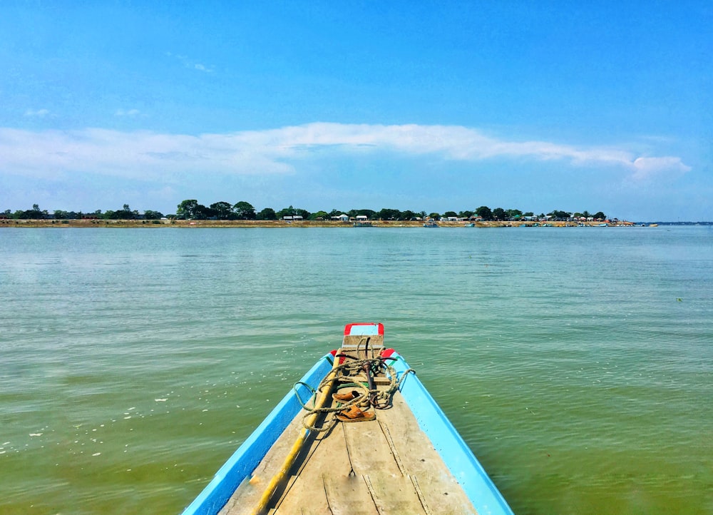 brown wooden boat on sea during daytime