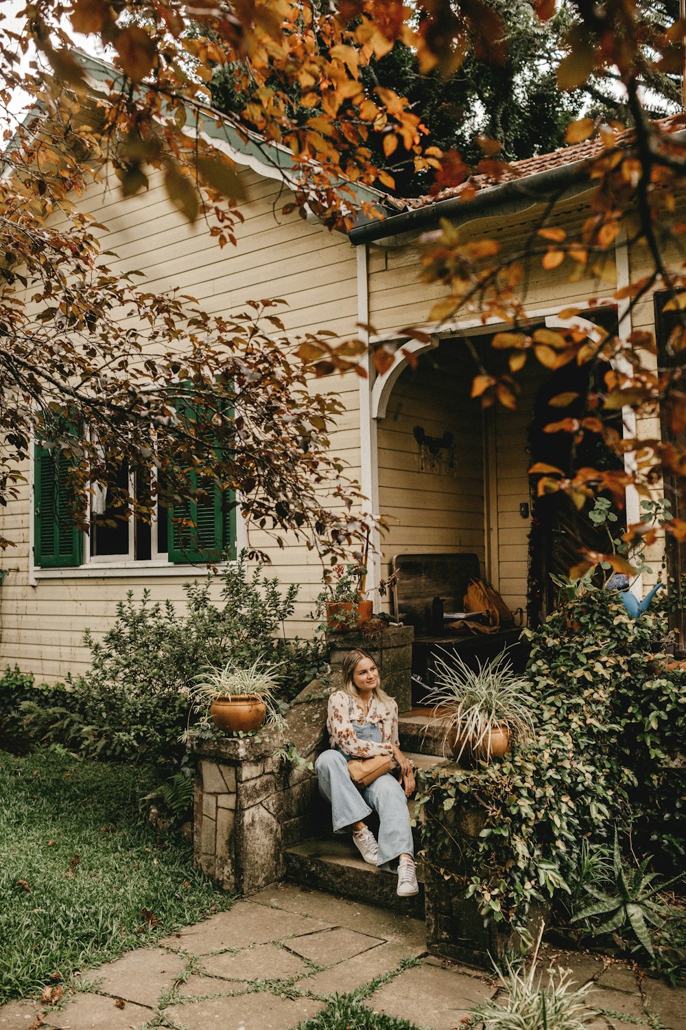 man and woman sitting on bench near green plants during daytime