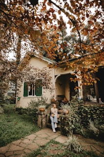 man and woman standing beside tree during daytime
