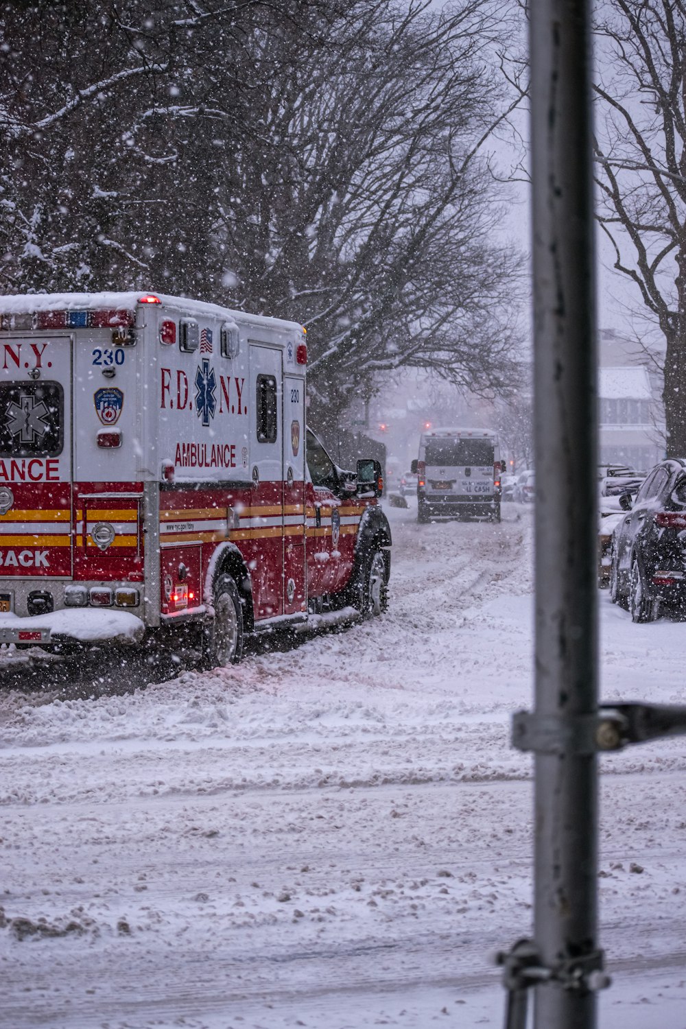 white and red van on snow covered ground during daytime