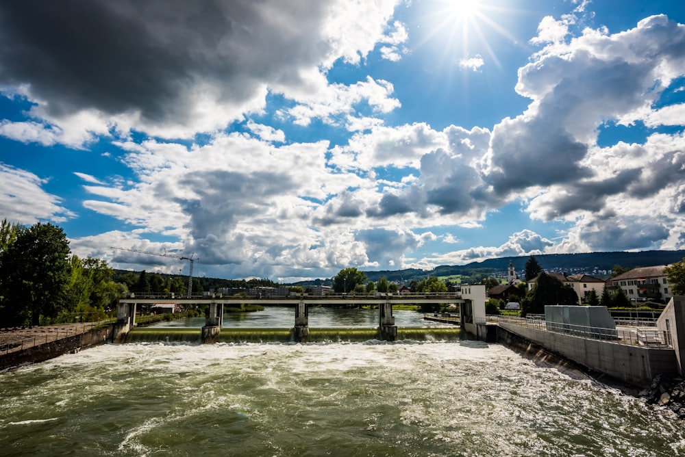 a large body of water with a bridge in the background