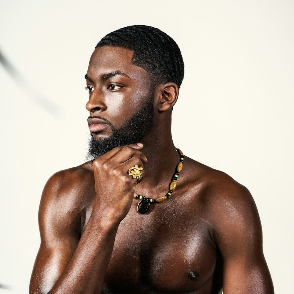 topless man with gold necklace