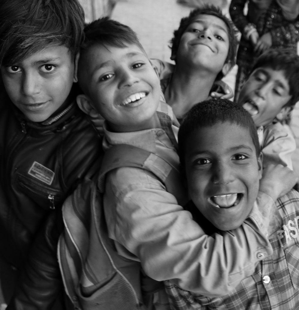 grayscale photo of 3 boys smiling