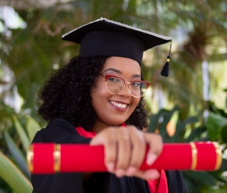 smiling woman wearing academic dress and black academic hat