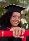 smiling woman wearing academic dress and black academic hat