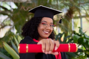 smiling woman wearing academic dress and black academic hat